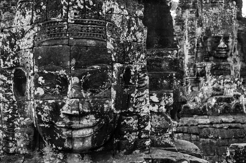 Carved stone faces on the upper towers of the Bayon Carved stone faces on the upper towers of the Bayon
