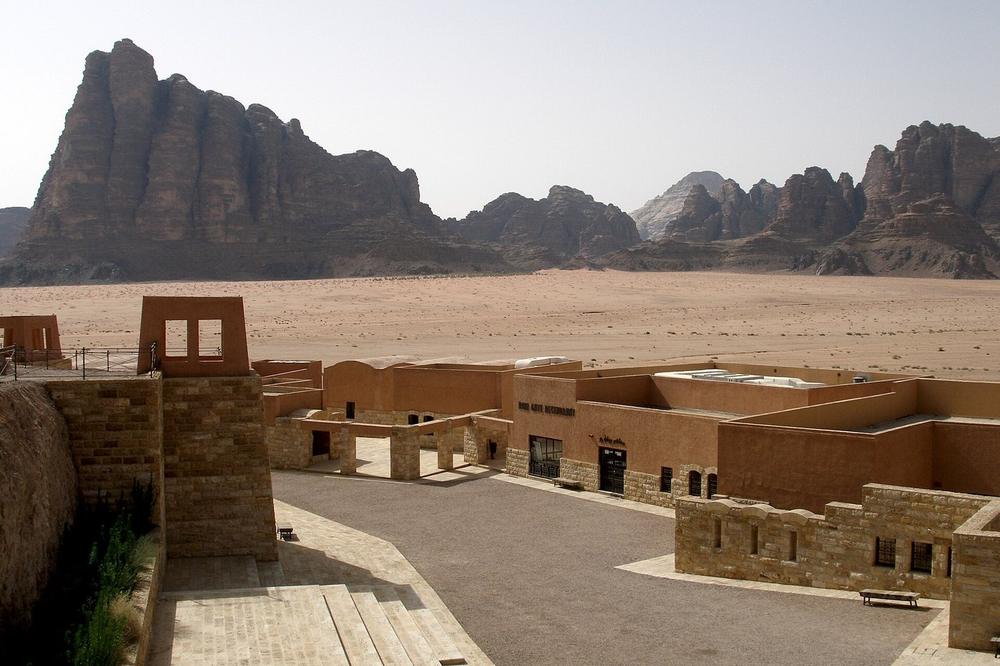 Sandstone towers standing out of red sand in Wadi Rum Sandstone towers standing out of red sand in Wadi Rum