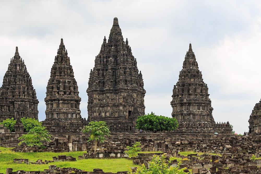 The tall stone towers of the Prambanan temple complex The tall stone towers of the Prambanan temple complex