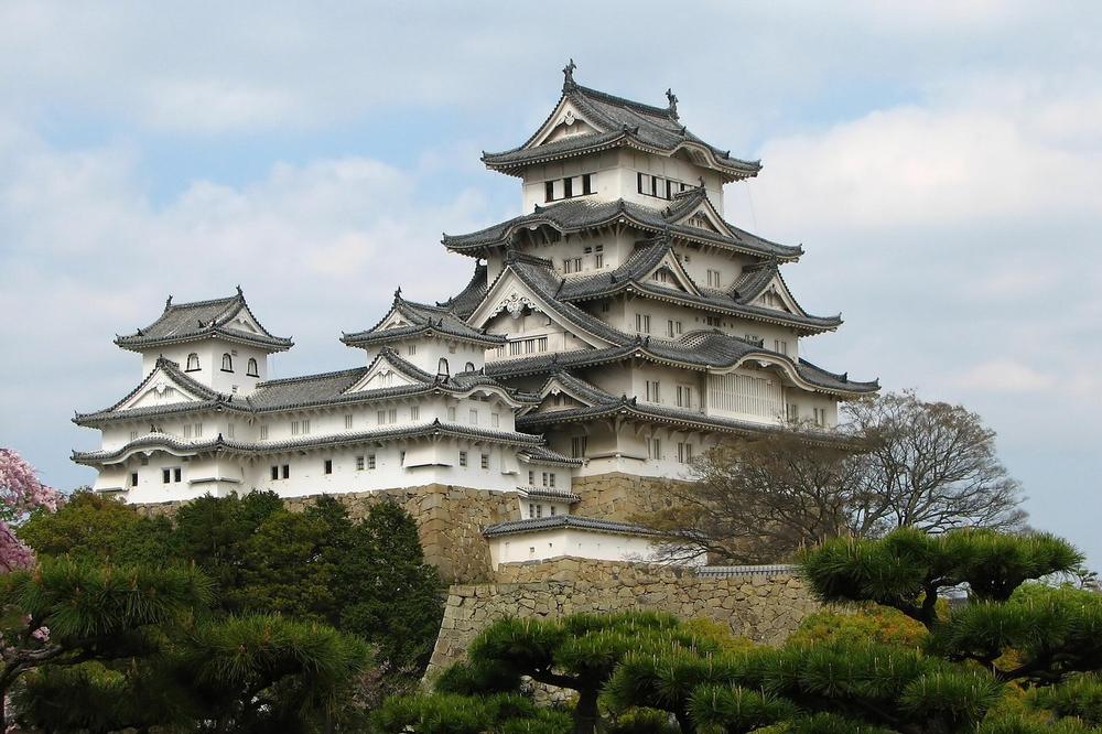 The white keep of Himeji Castle above its stone walls The white keep of Himeji Castle above its stone walls