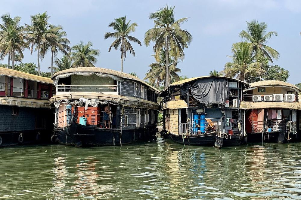 A houseboat moored in a narrow backwater canal near Alleppey A houseboat moored in a narrow backwater canal near Alleppey