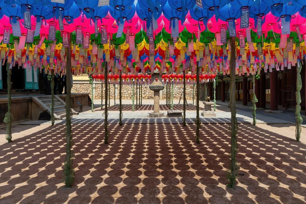 Lanterns strung across a monastery courtyard at dusk Lanterns strung across a monastery courtyard at dusk