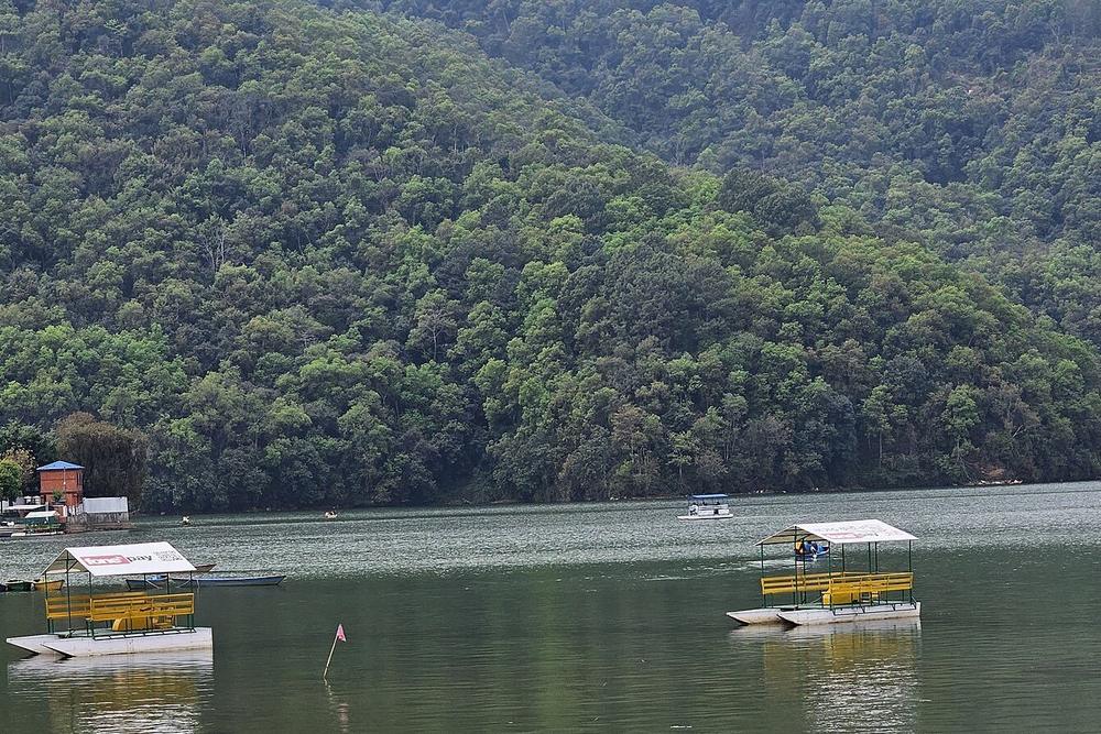 Rowed boats on Phewa lake at Pokhara with the hills behind Rowed boats on Phewa lake at Pokhara with the hills behind