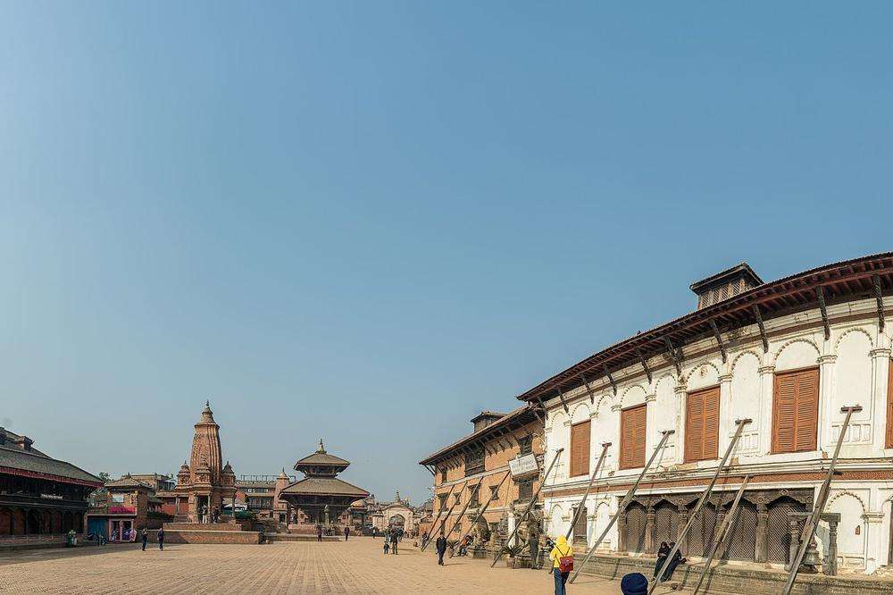 Wood-carved windows and brick facades on a square in Bhaktapur Wood-carved windows and brick facades on a square in Bhaktapur