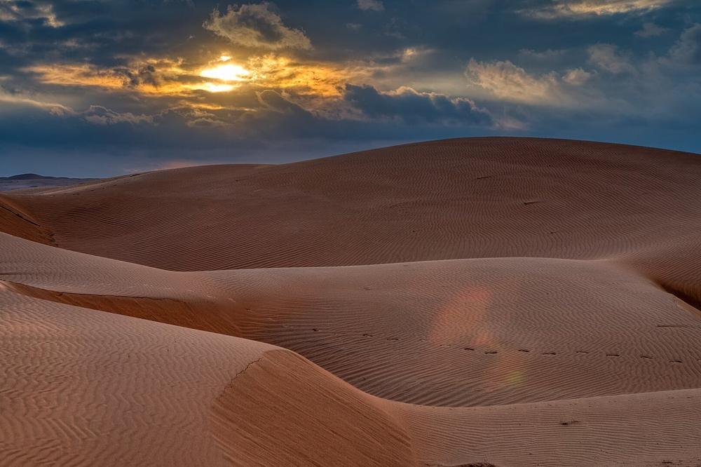 Ridges of red sand in the Sharqiya Sands at sunset Ridges of red sand in the Sharqiya Sands at sunset