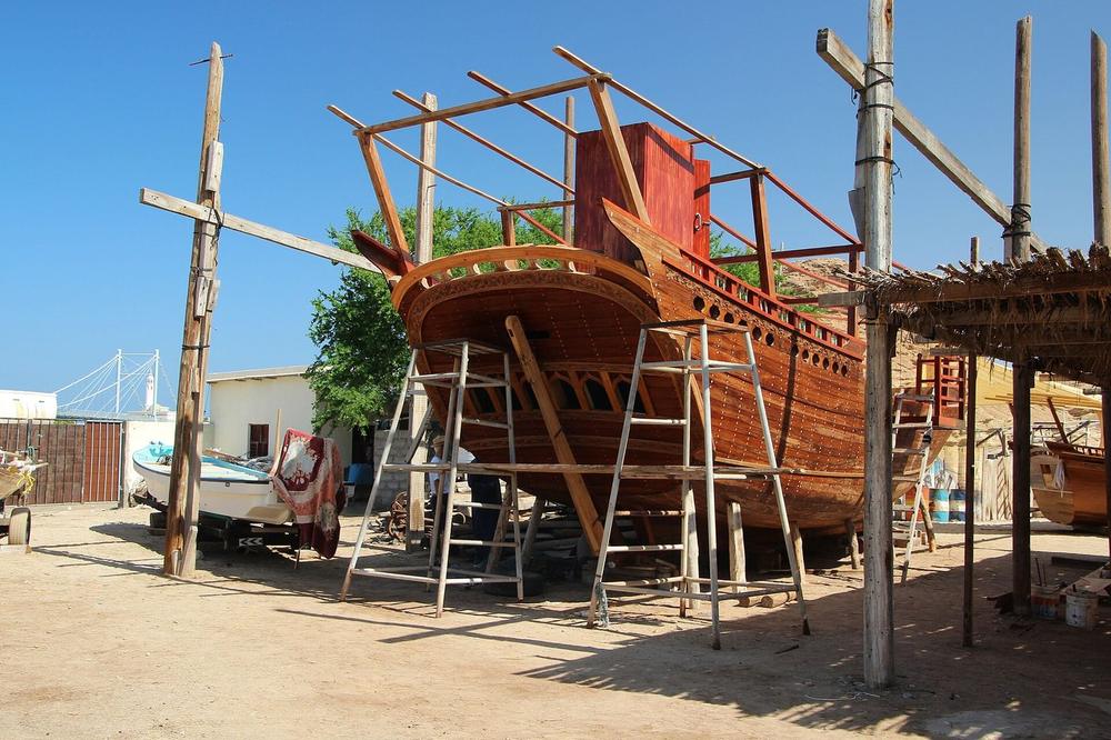 A wooden dhow under construction in a yard at Sur A wooden dhow under construction in a yard at Sur